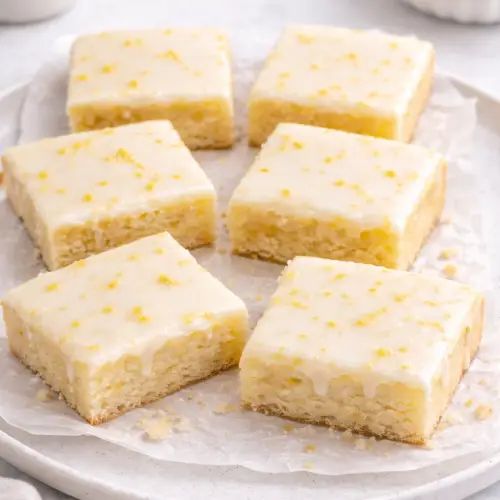Sweet and chewy lemon blondies with tangy frosting